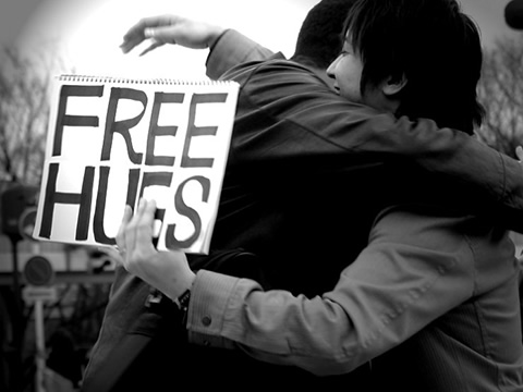 someone offering free hugs