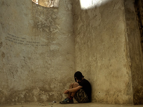 person sitting in the corner of a room